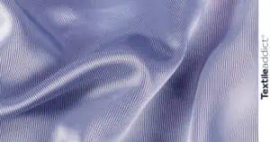 Gros plan de haute qualité d’un tissu extensible à base d’élasthanne, mettant en valeur son élasticité et sa texture, idéal pour les vêtements de sport et confortables.