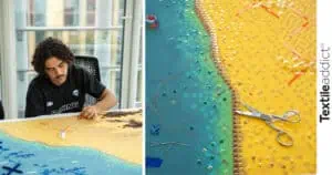 artiste textile en train de broder une oeuvre d'art